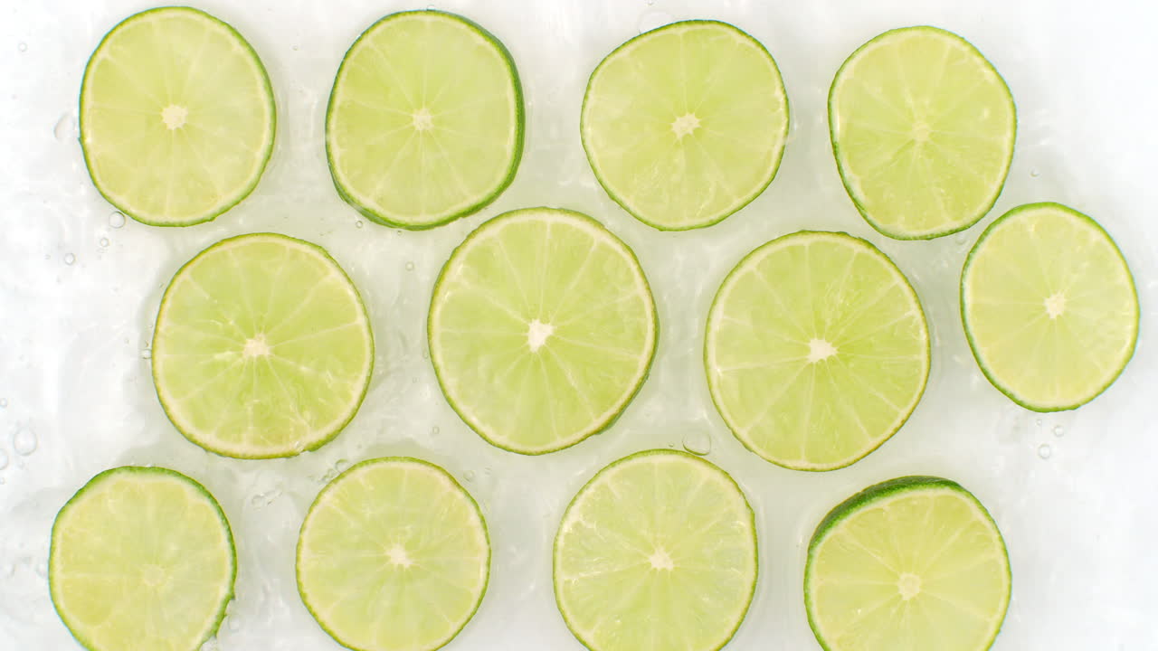 색 바탕에 개진 라임 조각을 물로 뿌리며, 느린 동작으로 매운 신선한 라임, 많은 라임 슬라이스를 뿌립니다.