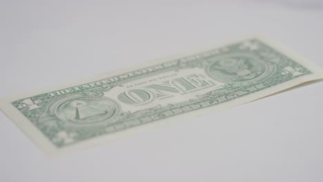 Close-Up-Currency-Shot-Of-Hand-Grabbing-US-1-Dollar-Bill-On-Marble-Background