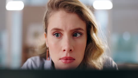 close-up of a concerned woman looking at a computer screen
