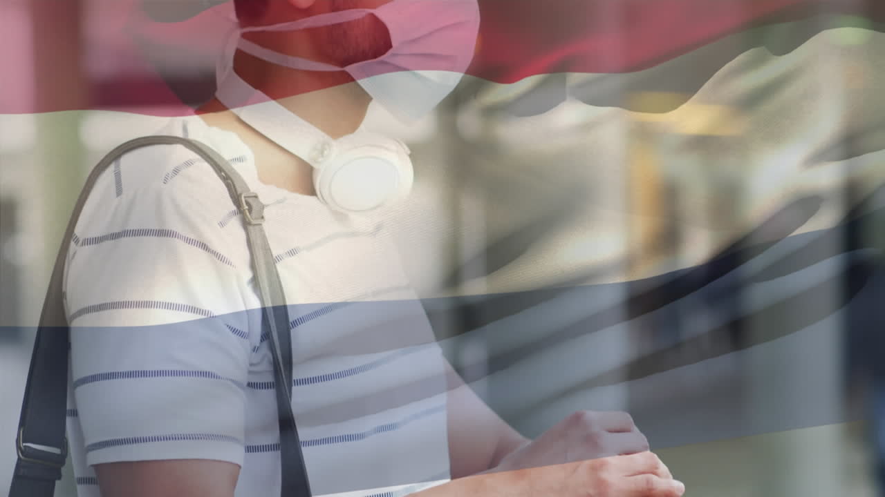 animación de la bandera de los países bajos ondeando sobre un hombre que usa una máscara facial durante la pandemia de covid-19