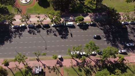 Aerial-tilt-down-shot-of-traffic-on-road-in-Buenos-Aires-City-during-sunny-day,-Argentina