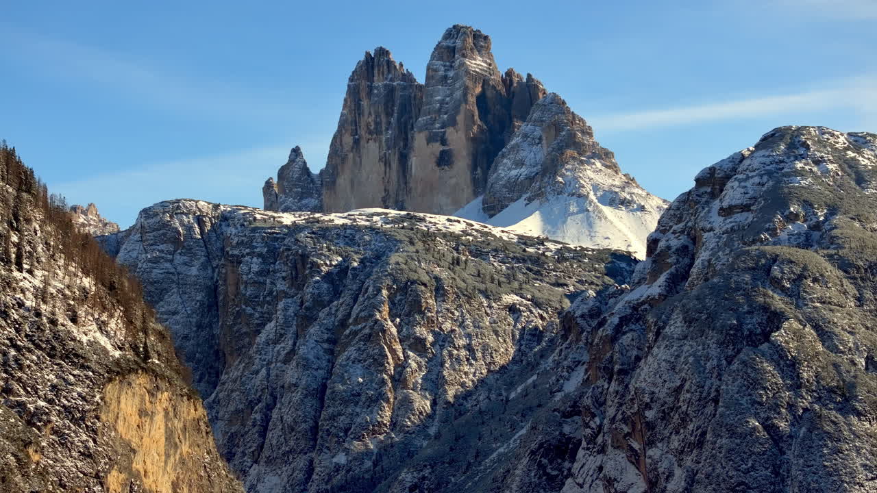 Aerial drone view of the Tre Cime di Lavaredo in the Sexten Dolomites of northeastern Italy with the blue sky on the background