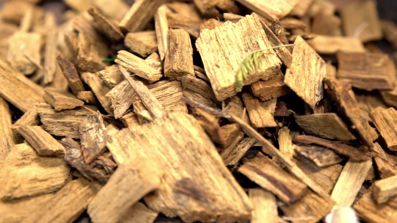 Wood chips being thrown into a heap after being broken down, Close up ...