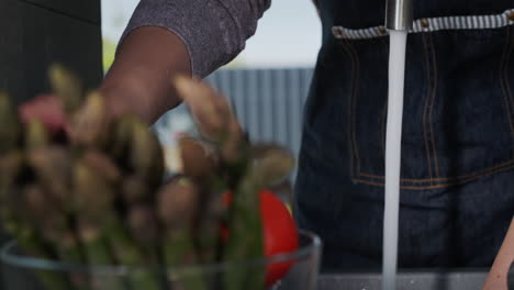 woman washes ingredients for salad 3