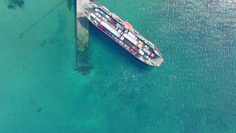 aerial bird eye view of ferry boat waiting at big island of chiloé, chile