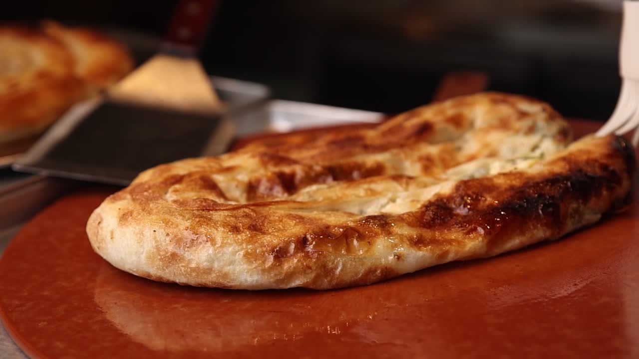 Hand Brushing Freshly Baked Golden Brown Savory Pastry