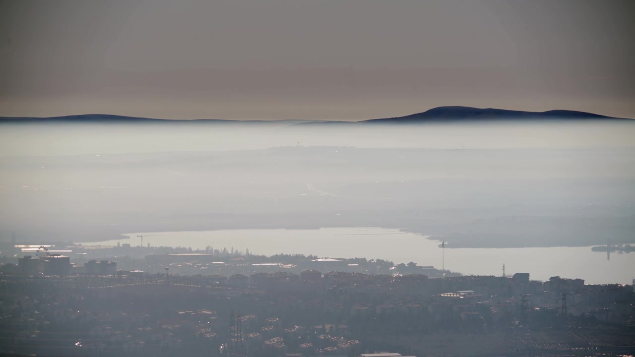 Aerial View of Cityscape Under Thick Layer of Morning Fog