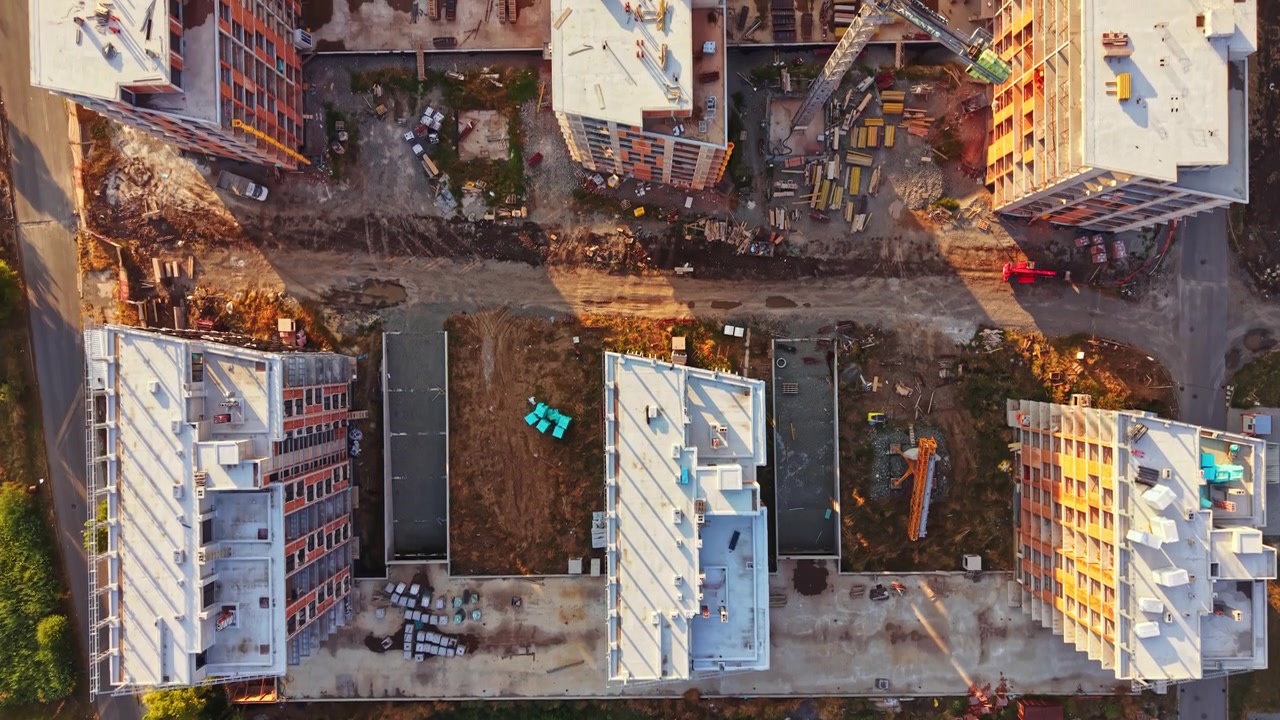 Construction site of new buildings in an urban area during sunset hours