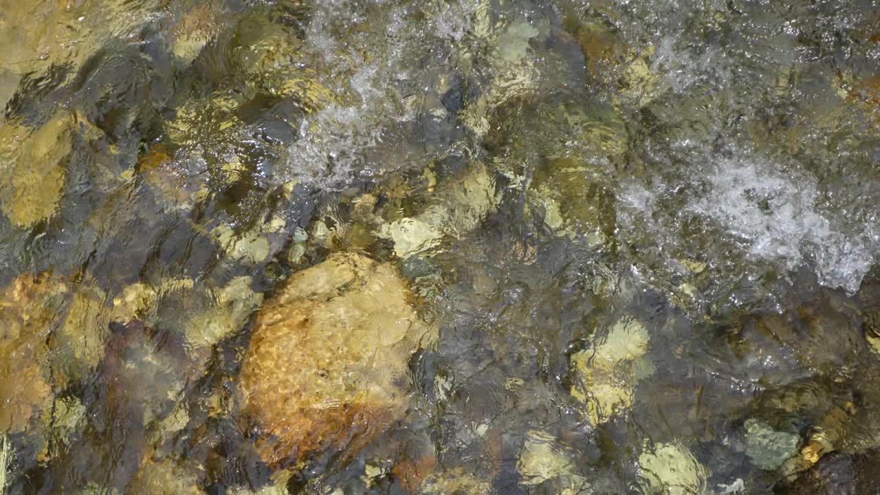Water is flowing through a mountain torrential river.