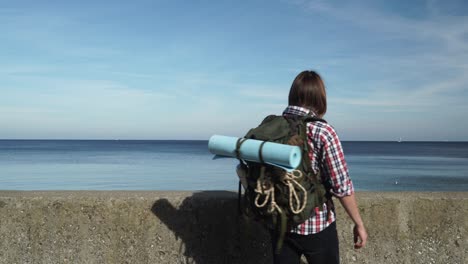 man hiker with backpack tramping by seaside 4k