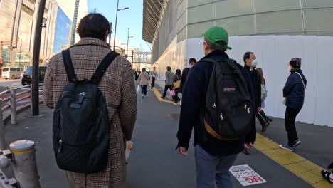 people walking across a busy urban crosswalk