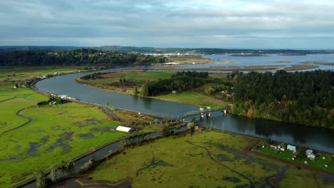 usa, or, coos bay, coos river hwy 241, 2024-11-24 - drone view of the green steel drawbridge, the flooded fields, the coos river, hwy 241, and the city of coos bay in the distance.