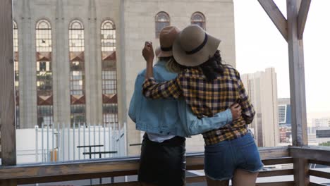 young adult friends hanging out on a rooftop