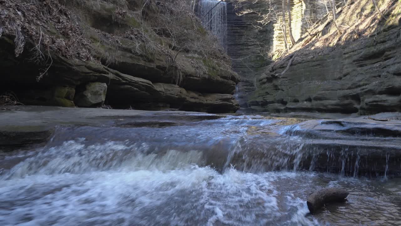 Forest valley waterfall and mountain river cascading down steps