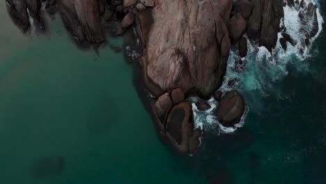 top down flyover revealing the entire arpoador rock in rio de janeiro just outside the ipanema beach neighbourhood popular place for locals to applaud the sunset