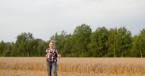 young positive female farmer dancing at farm