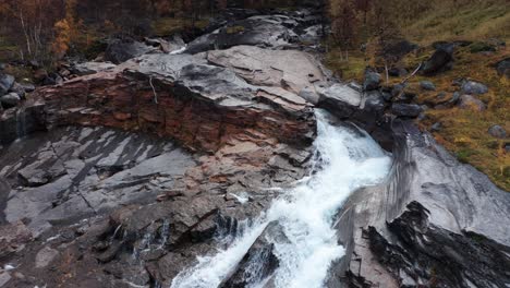 Aerial-view-of-the-shallow-mountain-river-rushing-through-the-rocky-riverbed