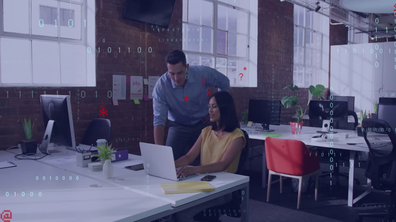Woman typing while male colleague leaning behind, causing code overlays over laptop for tech review