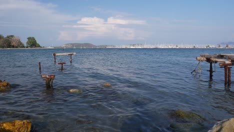 serene seascape with old wooden dock and sailboats in the distance