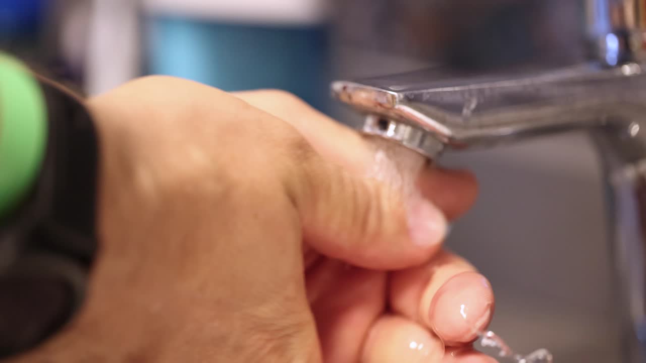 Close-up of a Person Washing Hands Under Running Water