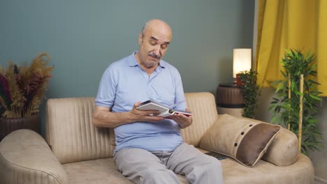 The-old-man-looking-at-the-family-album-is-happy.