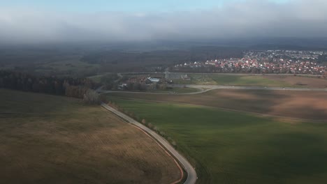 the drone soars over the picturesque countryside near hohenzollern, showcasing winding village roads.