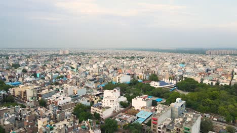 stunning aerial view of dwarka, delhi, with its high-rise buildings and wide roads under the bright sky.