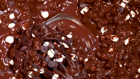 whisking chocolate chips into melted chocolate