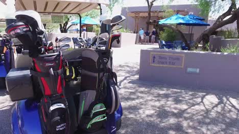 rotation around a golf cart holding two full golf bags ready for play