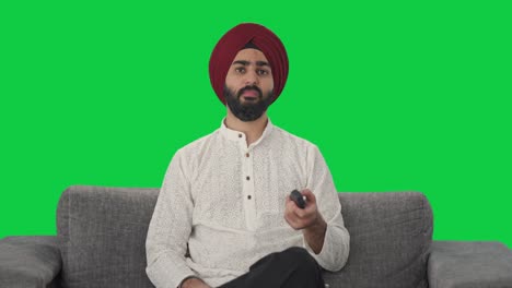 frustrated sikh indian man watching tv green screen