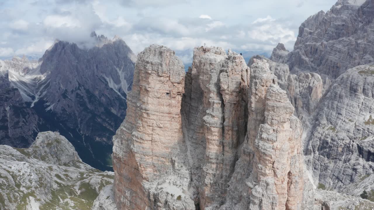 montañero descendiendo un pico de montaña en dolomitas italianas, tre cime, órbita aérea