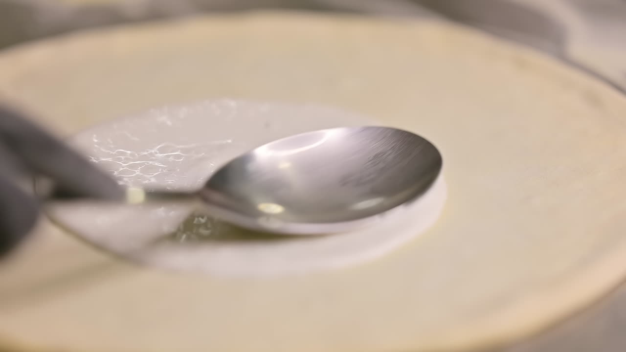Chef working in pizzeria. Hands of chef making pizza on floured black table