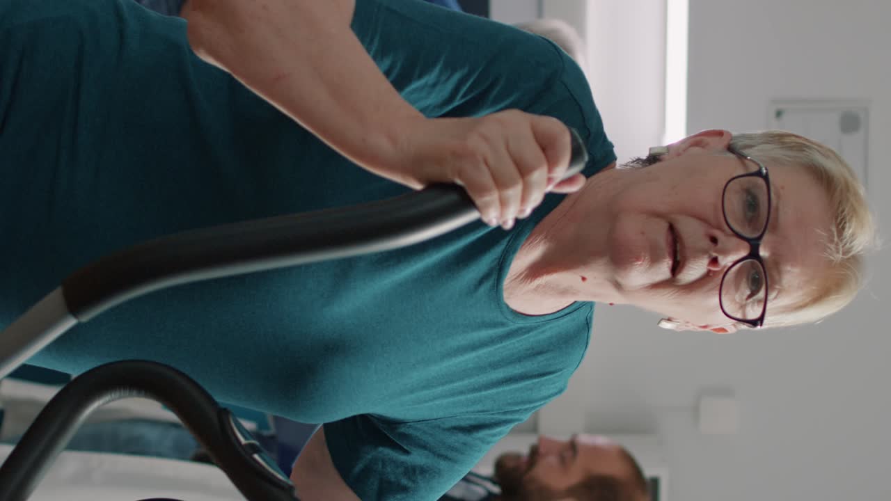 Portrait of senior woman doing physical therapy on stationary bicycle