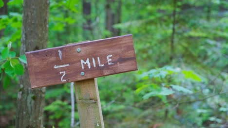 path half-mile marker sign in woods