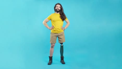 man with prosthetic leg standing confidently against blue background