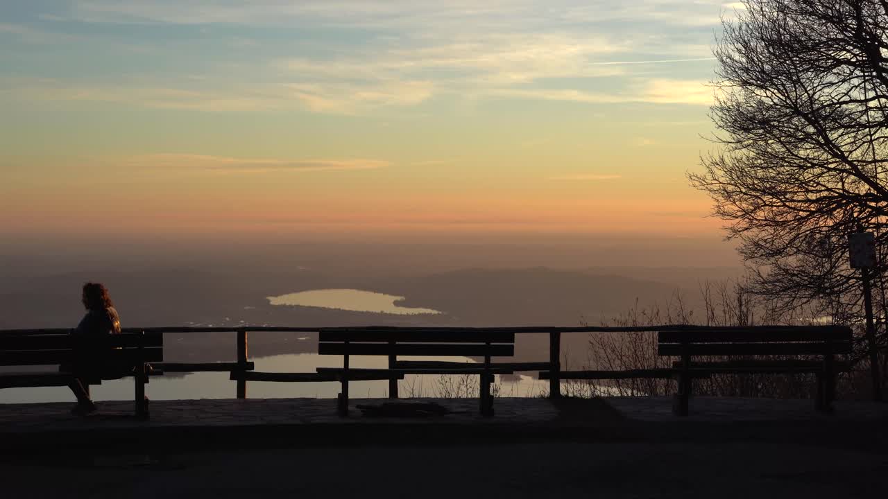 Woman alone on bench and panoramic view of campo dei fiori in Italy