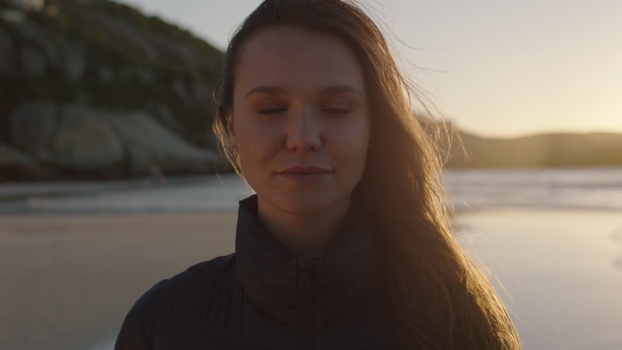 retrato en primer plano de una hermosa mujer joven sonriendo feliz mirando a la cámara disfrutando de un estilo de vida exitoso en el fondo de la playa al atardecer