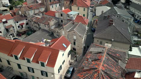Low-flight-at-dawn-over-red-rooftops-inside-Diocletian's-Palace---Split,-Croatia