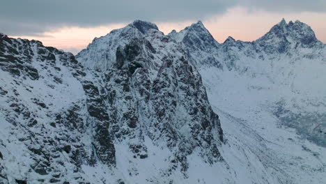 Lofoten-islands-extreme-frozen-elevated-mountain-summit-landscape-aerial-view-slowly-flying-forward