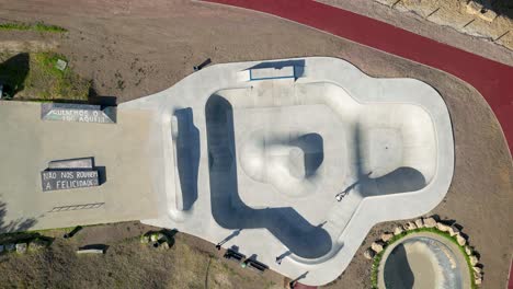 Aerial-Climbing-Shot-of-Skater-using-a-Skatepark-on-a-Sunny-Day