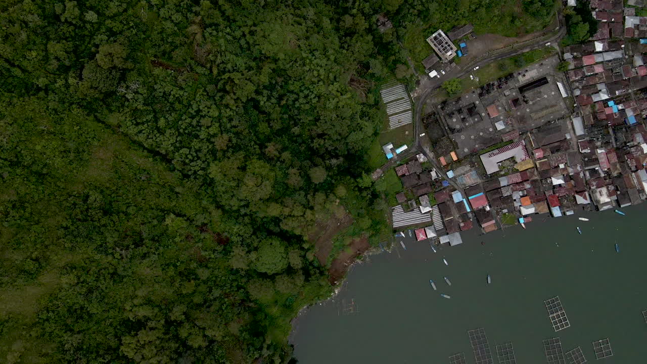 Tilt down view of fishing village in Bali. Drone