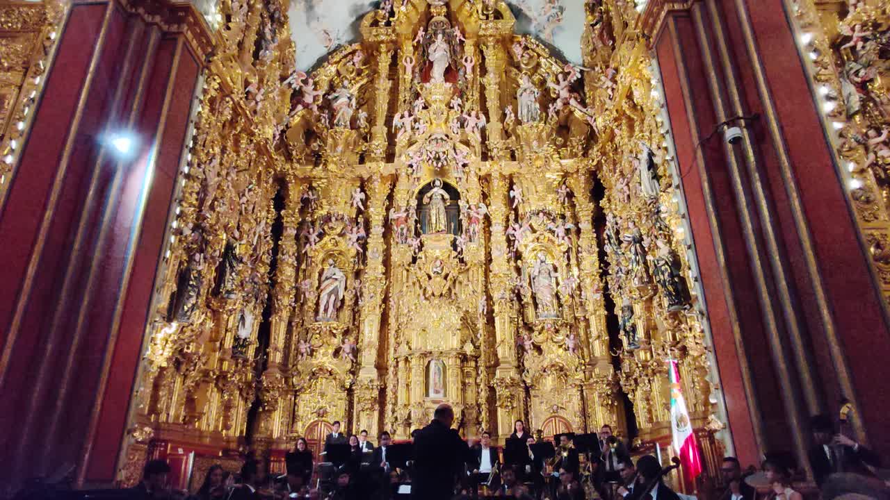 Philharmonic orchestra performing during the 60th anniversary of the National Museum of the Viceroyalty in Tepotzotlán, Mexico, with the altarpieces of the Temple of San Francisco Javier