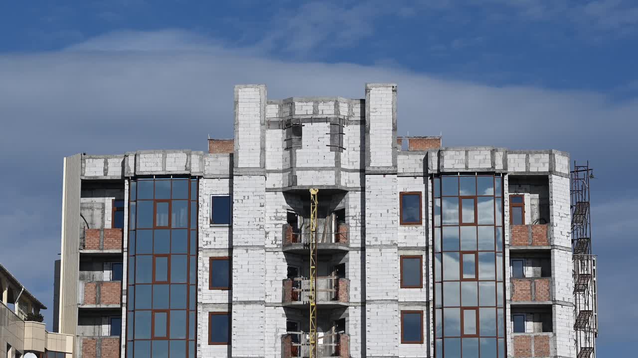 Time lapse of clouds moving on the blue sky above a building