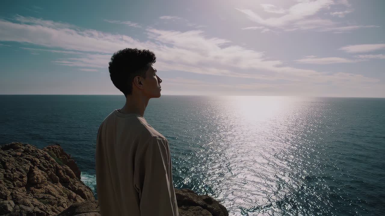 Man Contemplating Ocean View from Cliff