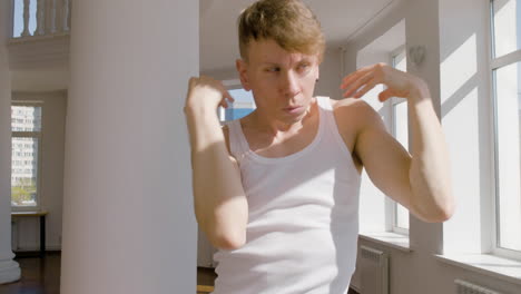 focused young man in casual wear performing a contemporary dance in the studio 1 1