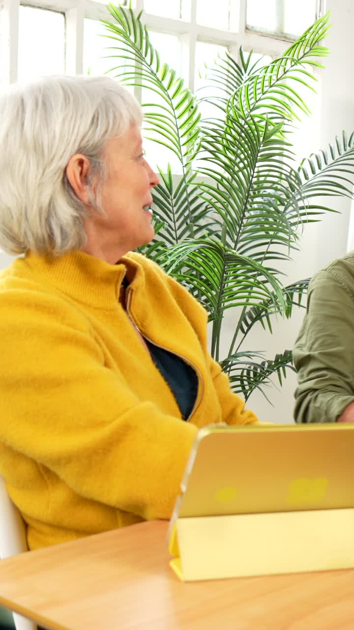 Senior Couple Using Tablet at Table