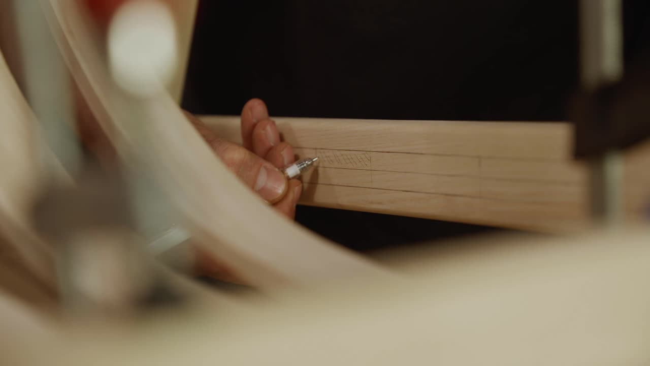 Close-up of a craftsman carefully marking precise measurements on a wooden frame, capturing focus, detail, and craftsmanship in furniture design and woodworking