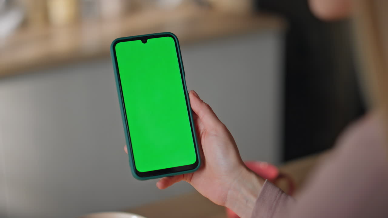 Girl scrolling mockup mobile phone making online order at home kitchen close up.