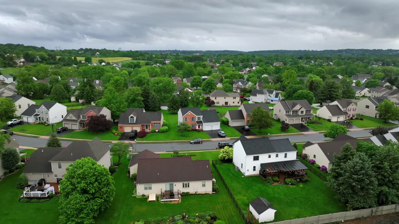 Row of single Family houses with garage in green Idyllic suburb district of american town. Rainy day in Pennsylvania Unites States. Spring Season with green grass gardens in Pennsylvania.