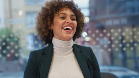 laughing african american businesswoman sitting at table in office meeting room